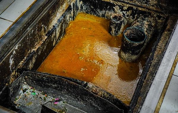 procrastinating on grease trap cleaning can lead to clogs, foul odors, and even fines from local authorities